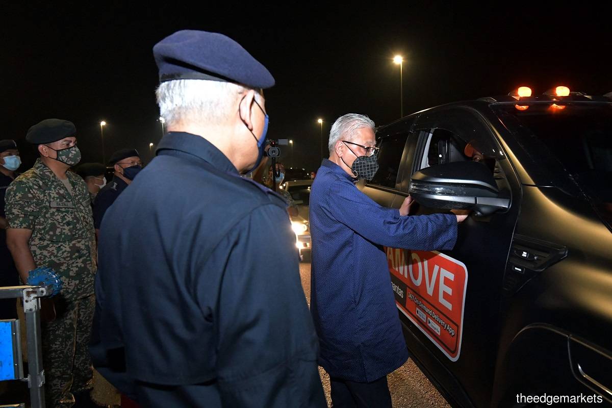 Ismail Sabri (right), meanwhile, advises the people to continue complying with the MCO and not to attempt crossing states and districts. (Photo by Mohd Suhaimi Mohamed Yusuf/The Edge)